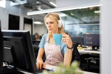 Young woman working focused on computer