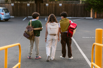 Teens with backpacks after class