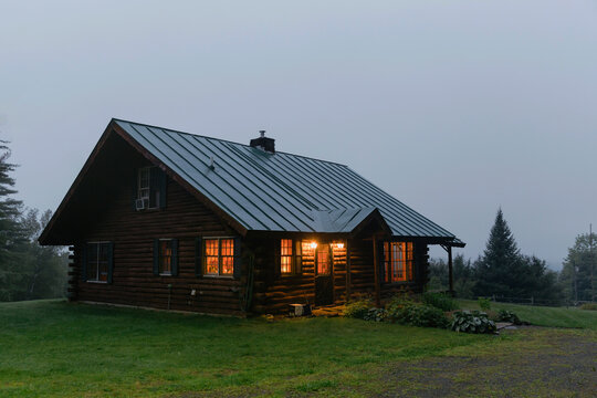 Cozy log cabin cottage home Vermont landscape at dusk in summer - Powered by Adobe