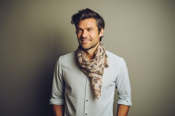 Obraz premium Portrait of a handsome man in a gray shirt and scarf.