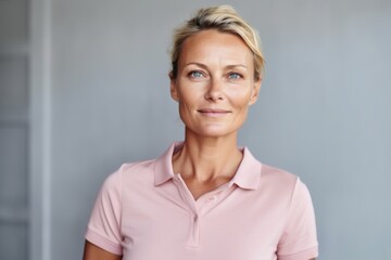 Fototapeta premium Portrait of mature businesswoman looking at camera while standing in office