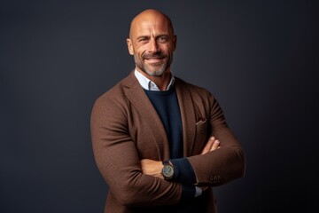 Portrait of a smiling mature man with arms crossed looking at the camera