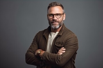 Obraz premium portrait of handsome middle aged man in eyeglasses looking at camera isolated on grey