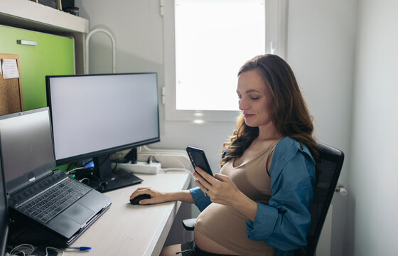 Freelance pregnant woman working in her home office