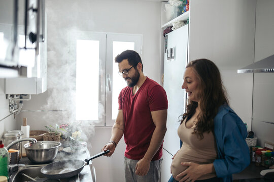 Pregnant woman with her husband in everyday life at home