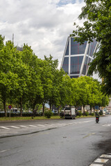 A characteristic building of the Madrid skyline seen between leafy trees