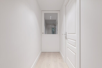 Corridor of a house with smooth white painted walls