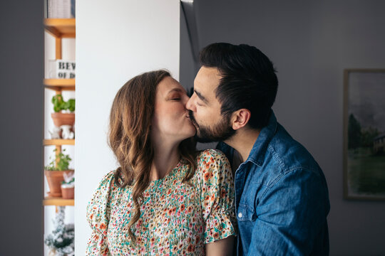 Portrait of a couple kissing at home