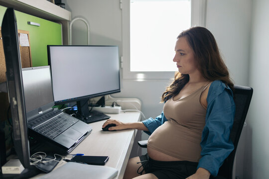 Freelance pregnant woman working in her home office