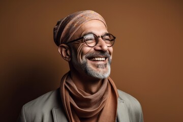 Obraz premium Portrait of a smiling middle-aged Indian man wearing a headscarf and glasses