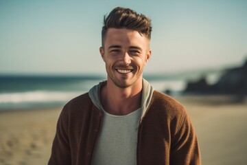 Portrait of smiling young man standing at beach on a sunny day
