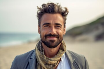 Portrait of handsome young man with beard and mustache on the beach