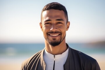 Portrait of smiling young man at beach on a sunny day in summer