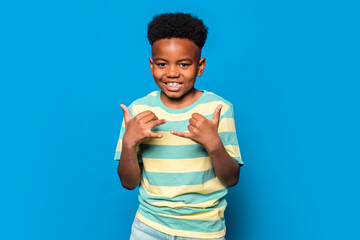 Cheerful black boy showing thumbs up