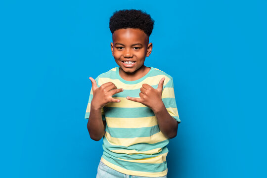 Cheerful black boy showing thumbs up