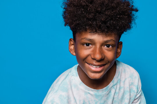 Cheerful black boy looking at camera