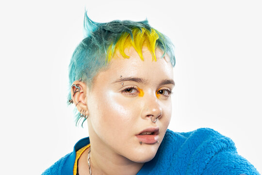 Multi-colored hair and creative make up and hairstyle. Trendy haircuts