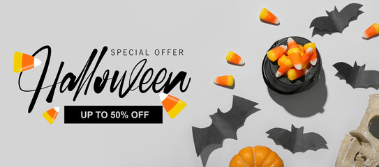Banner for Halloween sale with bats and corn candies on light background