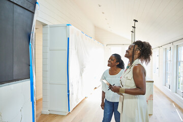 Black real estate agent showing a new construction home to client