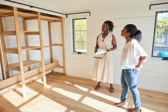 Black Woman Home Owner Buyer Talking With Real Estate Agent In House