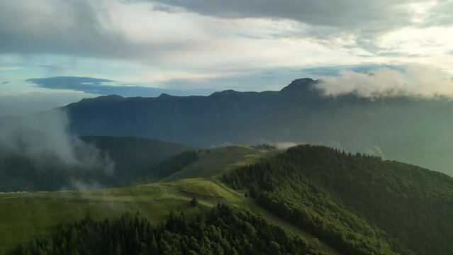 Carpathian Mountains captured by aerial drone footage in a foggy atmosphere.Cloudy summer day. Azuga, Romania.