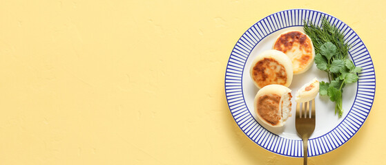 Plate with tasty cottage cheese pancakes and herbs on yellow background with space for text