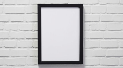 A black frame hanging on a white brick wall