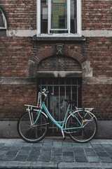 A blue bike parked in an alley in Brugge
