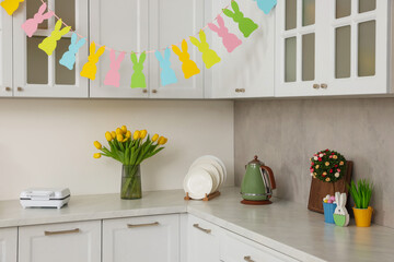 Colorful Easter decor and yellow tulips in kitchen