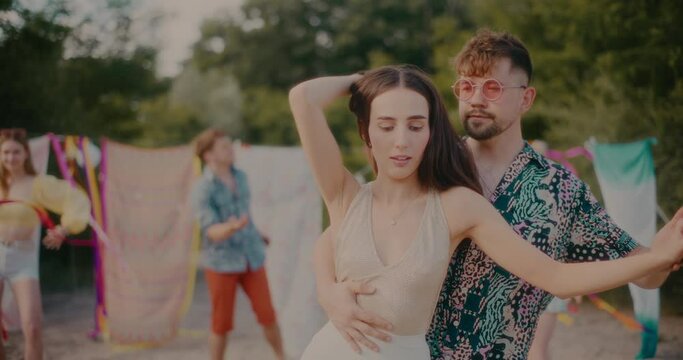 Young beautiful woman dancing bachata with handsome boyfriend