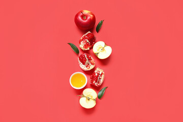 Composition with ripe apples, pomegranate and honey on red background. Rosh hashanah (Jewish New...