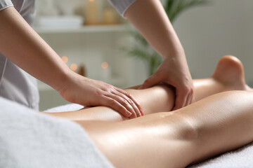 Obraz na płótnie Canvas Woman receiving leg massage in spa salon, closeup