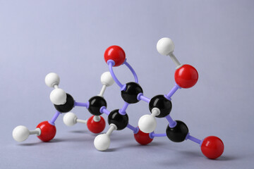 Molecule of vitamin C on light grey background. Chemical model