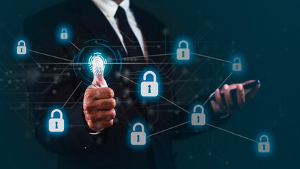 Businessman is showing thumb up to scan for unlock data while using smartphone against dark background.