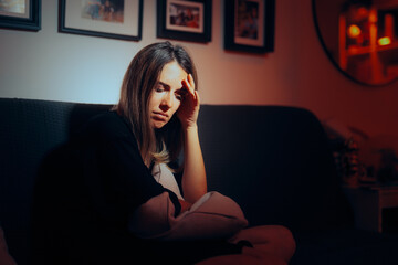 Sad Woman Suffering at Home after a Break-up. Heartbroken girl feeling desperate and alone 
