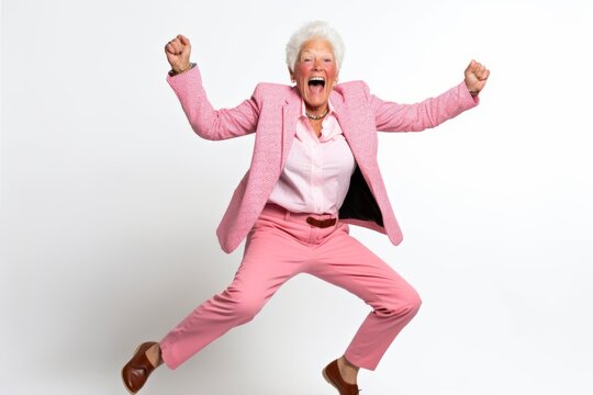 Full Length Portrait Of A Happy Senior Woman Jumping And Screaming Isolated Over White Background