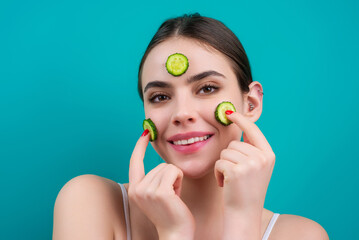 Facial mask of cucumber. Cosmetics, cosmetology, dermatology. Woman face with cucumber mask. Cosmetic procedure womans face in the mask with cucumber slices on face.