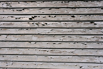 Sun-bleached fence with peeling paint