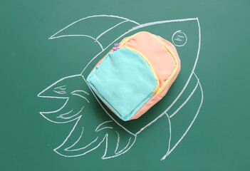 Drawn rocket with backpack on green background