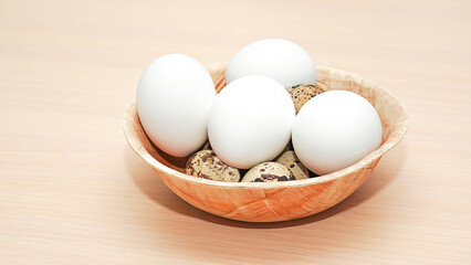 Chicken eggs and quail on a breakfast plate