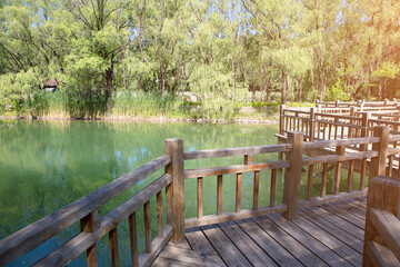 Naklejka na ściany i meble The trestle on the wooden bridge in the turquoise lake
