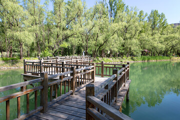 The trestle on the wooden bridge in the turquoise lake