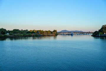 Fototapeta premium sea level view of Gladstone marina with Mount Larcom in the distance, Queensland, Australia