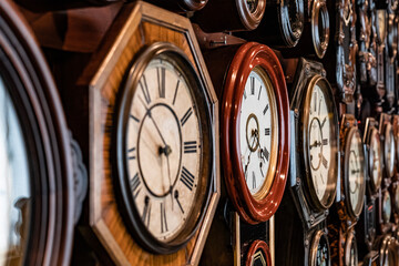 There are many old wall clocks
