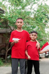 happy indonesian kids with flag at outdoor