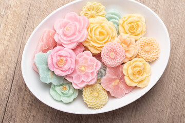 A-lua or Allure Thai handmade candy in a mini bowl on gray desktop. A-lua Thai dessert. Copy space.