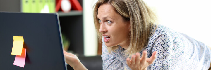 Financial problem, unexpected results, lack of money. Confused and stressed woman looking at computer screen.