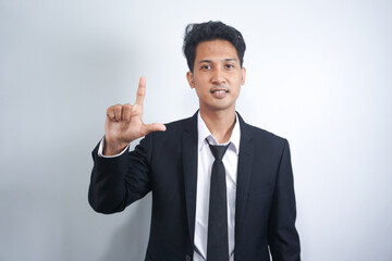 Hand, loser and fail with a business Asian man in studio isolated on a white background to gesture an L sign. Social media, emoji and review with a male employee giving feedback on blank space