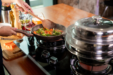 asian woman cooking at kitchen her beautiful parents cooking together in kitchen at home