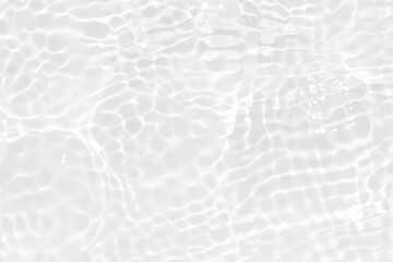 White water with ripples on the surface. Defocus blurred transparent white colored clear calm water surface texture with splashes and bubbles. Water waves with shining pattern texture background.